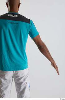 Tiago  1 arm back view blue t shirt dressed…